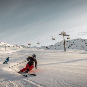 two skiers carving on the slopes in ski school private lessons