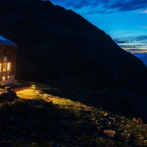 Hut with lights on the mountain at night