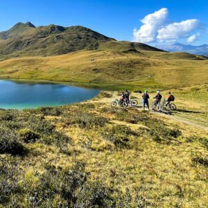 Group of mountain bikers by the lake in Davos Klosters